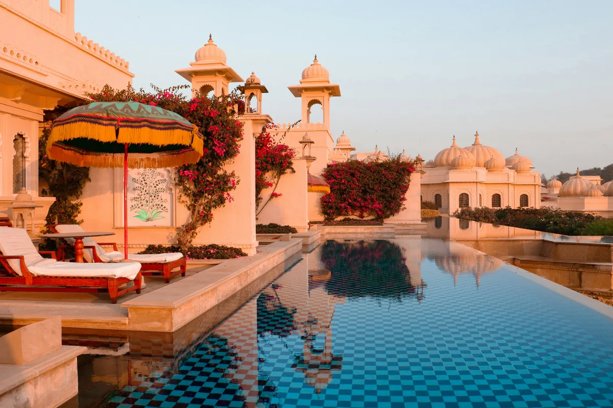 Luxury palace hotel with an ornate pool terrace at sunset