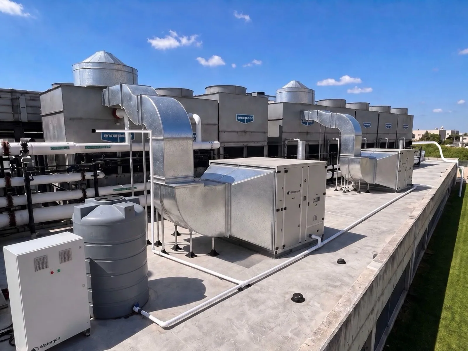 Watergen units generating water beside rooftop cooling towers